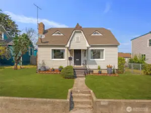 With its storybook gable roof and charming front path, this home feels like a warm welcome the moment you arrive.