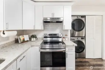 Sleek stainless range with subway tile backsplash, just steps from the back porch for easy indoor-outdoor dining.