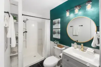 A bold accent wall and modern finishes elevate this bathroom, pairing style with everyday function.