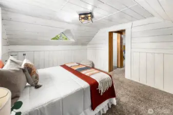 This inviting upstairs retreat offers warmth and privacy, tucked away under classic sloped ceilings.