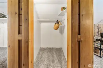 Deep upstairs closet provides practical storage while keeping the room clutter-free.