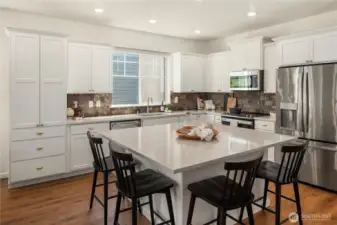 This stunning kitchen looks as good as it functions with an immense center island that seats 4 comfortably.