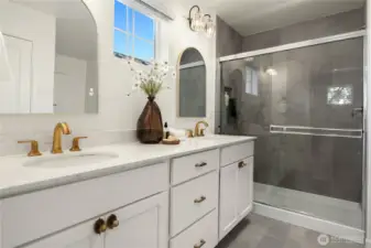 Twin undermount sinks and brass fixtures give this vanity an elegant look.