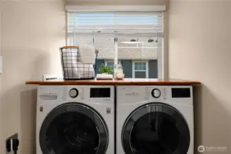 Front loading full-size washer and dryer with hardwood folding table stay with the house.