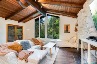 Cozy living space with fireplace and access to the private deck