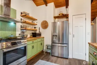 Built in panty next to the refrigerator with slide out drawers