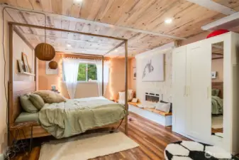 Cozy fireplace and sitting area in this captivating second primary on the lower level