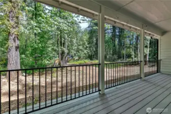 Covered back porch overlooks backyard.