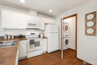 Charming, easy-to-maintain kitchen with easily accessible washer and dryer.