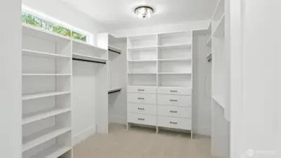 Two Custom Walk-In Closets in the Primary Suite:  One of two primary suite closets - Generous built-ins, open shelving, and tailored drawer systems make these closets as functional as they are beautiful. Bright, organized, and spacious, it’s a boutique-style dressing room that completes the suite’s sense of elevated daily living.