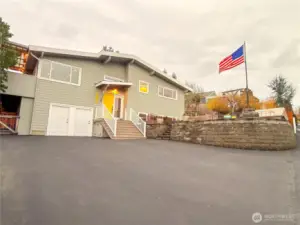 The front porch roof is new, new door, the side and upper window above was rebuilt plus resided, the entire house has been repainted. The original 1 car garage has been transformed into a workshop/ storage area (left door) and a private entry door leading to the lower-level living area (right door) Can easily be returned to a 1 car garage