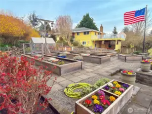 A gardeners dream yard includes old growth cedar raised beds, paver walkways and your own greenhouse.