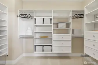 Spacious walk-in closet with custom built-ins.