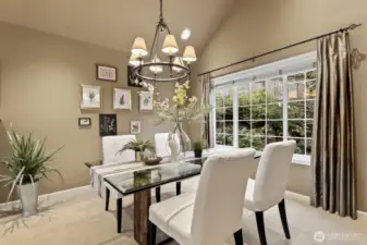 The dining room has space for sharing intimate meals or entertaining a group. Custom window coverings throughout the house further elevate the homes polished aesthetic.