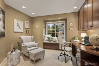 A main floor office just off the entry features French doors, a charming window seat.