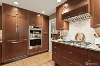This beautifully designed kitchen has High-end Miele, Bosch, and DCS appliances, including a paneled refrigerator, gas cooking and a double oven.