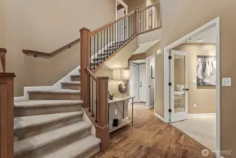 Rich hardwood floors and the custom built stair railings showcase the elegance of this front entrance.