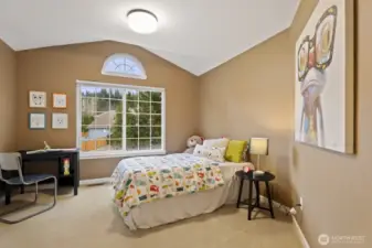 The second bedroom, across from the primary suite, includes large windows with elevated views of the neighborhood and a useful closet system to help keep things organized.