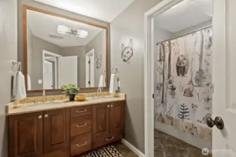 A remodeled guest bath with high end fixtures and tile work make this bathroom a joy to use.