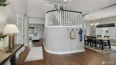 A welcoming entry greets you with beautiful flooring, soaring ceilings, and a striking curved staircase that sets the tone for the home.