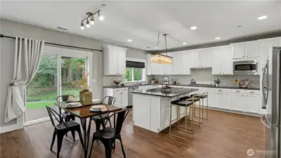 Large windows and a sliding glass door bring in natural light while connecting you to the backyard patio.