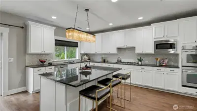 The spacious island offers the perfect place for meal prep, casual dining, or gathering with guests.