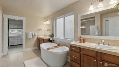 Unwind in the spa-inspired primary ensuite featuring a relaxing soaking tub and dual vanities.