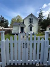 The white picket fence and gate welcome you into your fully fenced yard.