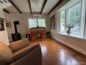 Beamed ceilings continue through the family room.