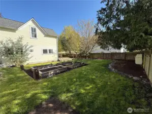 Expansive grassy yard and garden space.