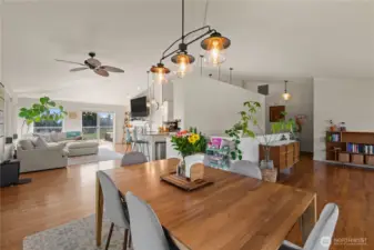 Looking room the dining room toward the family room on the left, the kitchen in the middle, and the sitting room on the right.