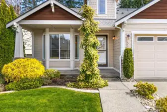 Covered front porch with mature front landscaping