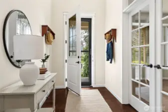 Grand entry with vaulted ceilings and gleaming engineered hardwood floors.