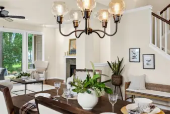 Dining room conveniently located off kitchen with views to golf course through living room. Designer light fixtures really make this home shine