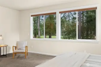 Tranquil views of golf course from primary suite through 2 large windows.