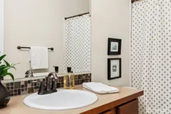 Main floor bathroom has full tub/shower combo