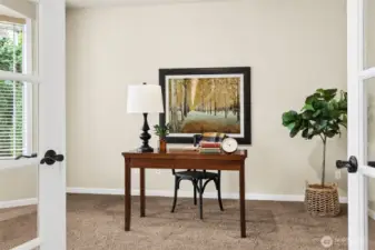 Office with glass French doors and bay window has views out to front of house