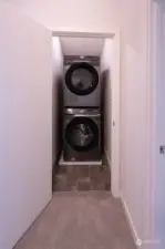 Stacked washer-dryer on upper level.