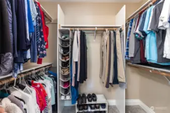 large walk in closet with shelving.