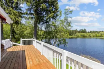 Morning or evening beverage? It's the perfect outdoor space! This roomy brand-new deck leads down to the lower covered deck and out onto the lake beyond.