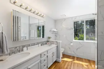 Here's the frosting on the cake, the stunning primary ensuite has been remodeled with tiled walls, hardwood floors, quartz counter, custom backsplash and double vanity for beauty and convenience.