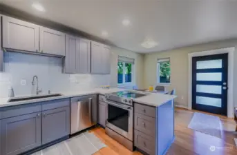 Good sized kitchen, stainless steel appliances, Bamboo flooring are open to the dining and living rooms.   Great open feel and well designed floor plan throughout this home.