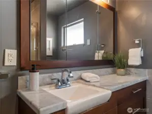 Single vanity with marble top and original sink.