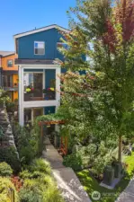 The home's entry is tucked beyond this beautiful garden pathway and courtyard.