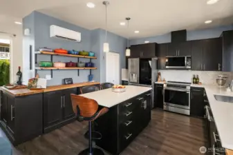 Custom cabinetry and shelving beautifully elevates the space and offers tons of additional storage. Note the ductless mini-split (one of three added).