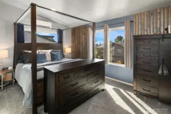 Southwest-facing primary en suite bedroom. That transom window is perfection and the 20-year carpet with Nike Grind moisture-proof padding that protects the sub floor is a thoughtful addition. Note minisplit #2.