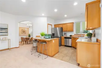 Adjacent to the living room is the delightful kitchen embellished with all sparkling stainless appliances including a new oven range, newer 2024 refrigerator, new garbage disposal, new sink & faucet and a walk-in pantry.