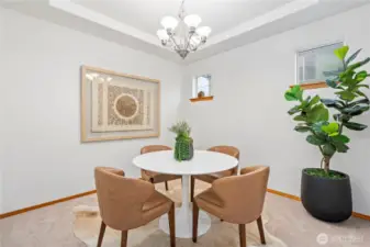 Savor delicious meals in this elegant formal dining room with beautiful tray ceiling.