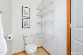 Main floor powder room with shelving for your storage needs.