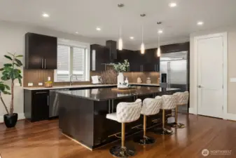 Chef's kitchen with GE Monogram appliance package and spacious walk-in pantry storage